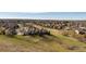 Expansive aerial view of townhomes in a community with green spaces and mountain views at 3661 S Perth Cir # 6-101, Aurora, CO 80013