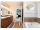Bathroom featuring double vanity and separate tub/shower room entrance to bedroom at 3661 S Perth Cir # 6-101, Aurora, CO 80013