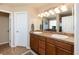 Bathroom featuring double vanity with wooden cabinets and neutral wall paint at 3661 S Perth Cir # 6-101, Aurora, CO 80013