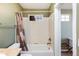 Bright bathroom showcases tiled bathtub, shower with window, and modern fixtures at 3661 S Perth Cir # 6-101, Aurora, CO 80013