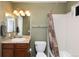 Functional bathroom features vanity, toilet, and shower-tub combo with curtain at 3661 S Perth Cir # 6-101, Aurora, CO 80013