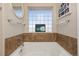 Soaking tub with tile surround and a block window for natural light at 3661 S Perth Cir # 6-101, Aurora, CO 80013