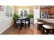 Charming dining area with wood floors, natural light from a large window, and views of the modern kitchen at 3661 S Perth Cir # 6-101, Aurora, CO 80013