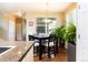 View of eat-in kitchen dining area features a square dark wood table at 3661 S Perth Cir # 6-101, Aurora, CO 80013
