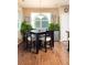 Eat-in kitchen dining area features a square dark wood table and leafy plants at 3661 S Perth Cir # 6-101, Aurora, CO 80013