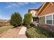 Well-maintained exterior showcasing beautiful landscaping, a walkway, and a combination of stone and green siding at 3661 S Perth Cir # 6-101, Aurora, CO 80013
