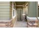 Inviting front porch with green siding, stone accents, and a covered entryway, creating a welcoming entrance at 3661 S Perth Cir # 6-101, Aurora, CO 80013