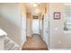Bright hallway with tile flooring, white trim, staircase, and multiple doorways offering access to various areas of the home at 3661 S Perth Cir # 6-101, Aurora, CO 80013