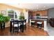 Open concept kitchen with stainless steel appliances, wood floors, and a dining area with a large window at 3661 S Perth Cir # 6-101, Aurora, CO 80013