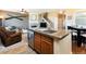 Kitchen island with granite counter, stainless steel dishwasher, and wood cabinets at 3661 S Perth Cir # 6-101, Aurora, CO 80013