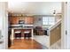 Open concept kitchen and living area featuring hardwood floors, granite countertops, and a cozy seating area at 3661 S Perth Cir # 6-101, Aurora, CO 80013