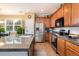 Open kitchen design with granite counters, stainless appliances, and abundant natural light from the window at 3661 S Perth Cir # 6-101, Aurora, CO 80013
