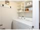 Organized laundry room featuring washer, dryer, and built-in shelving at 3661 S Perth Cir # 6-101, Aurora, CO 80013