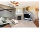 Cozy living room with a fireplace, television, and staircase at 3661 S Perth Cir # 6-101, Aurora, CO 80013