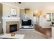 Bright living room with fireplace, TV, and stairway to the upper level at 3661 S Perth Cir # 6-101, Aurora, CO 80013