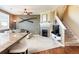 Living room featuring a fireplace, mounted television, staircase and neutral decor at 3661 S Perth Cir # 6-101, Aurora, CO 80013