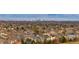 Panoramic shot showcases a neighborhood with tree-lined streets, varied architectural styles, and a city skyline backdrop at 3661 S Perth Cir # 6-101, Aurora, CO 80013