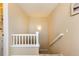 Stairway with neutral paint and white banister leading to the upper level at 3661 S Perth Cir # 6-101, Aurora, CO 80013