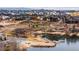 Scenic aerial view of a lakefront community with sandy beaches and lush landscaping at 12648 Waterside Ln, Longmont, CO 80504