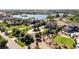 Expansive aerial view highlighting the home's large lot, mature trees, and proximity to the lake at 12648 Waterside Ln, Longmont, CO 80504