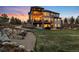 A spacious backyard featuring a fire pit and multi-level deck, perfect for entertaining at 12648 Waterside Ln, Longmont, CO 80504