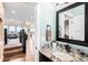 Chic bathroom with granite countertop, a black framed mirror, and modern fixtures at 12648 Waterside Ln, Longmont, CO 80504
