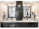 Bathroom featuring dual sinks with granite countertops and dark wood cabinetry at 12648 Waterside Ln, Longmont, CO 80504