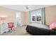 Comfortable bedroom with neutral walls, bright window, ceiling fan, and a walk-in closet at 12648 Waterside Ln, Longmont, CO 80504