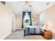 Bedroom with a high ceiling, a ceiling fan, and a window with outdoor views at 12648 Waterside Ln, Longmont, CO 80504