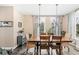 Elegant dining room with a large wooden table, wicker chairs, and stylish light fixtures at 12648 Waterside Ln, Longmont, CO 80504