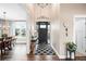 Inviting entryway with a black front door, patterned rug, and stylish decor at 12648 Waterside Ln, Longmont, CO 80504