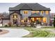Attractive home with stone accents, a well-manicured lawn, and a curved walkway leading to the welcoming front entry at 12648 Waterside Ln, Longmont, CO 80504
