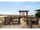 Charming fenced garden area with an arbor, providing a tranquil spot for gardening and enjoying the outdoors at 12648 Waterside Ln, Longmont, CO 80504
