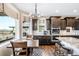Eat-in kitchen featuring dark cabinets, granite countertops, and stainless steel appliances at 12648 Waterside Ln, Longmont, CO 80504