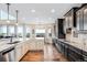 Gourmet kitchen with granite countertops, stainless steel appliances, and a breakfast bar with scenic views at 12648 Waterside Ln, Longmont, CO 80504