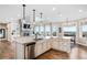 Bright, open kitchen features a large island, stainless steel appliances, and a cozy fireplace at 12648 Waterside Ln, Longmont, CO 80504