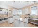 Functional laundry room with ample counter space, storage cabinets, and modern appliances at 12648 Waterside Ln, Longmont, CO 80504