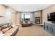 Cozy living room featuring a stone fireplace and comfortable leather sofas at 12648 Waterside Ln, Longmont, CO 80504