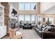 Bright living room featuring a stone fireplace, soaring ceilings, and large windows with scenic views at 12648 Waterside Ln, Longmont, CO 80504
