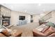 Spacious living room boasts a stone fireplace, media center, and adjacent dining area at 12648 Waterside Ln, Longmont, CO 80504