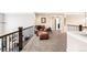 Cozy loft area with a leather chair, ottoman, and carpeted floors at 12648 Waterside Ln, Longmont, CO 80504