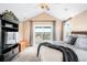 Bright main bedroom featuring high ceilings, large windows, a ceiling fan, and access to a balcony with lovely views at 12648 Waterside Ln, Longmont, CO 80504