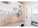 Organized mudroom with a built-in bench, storage shelves, and coat hooks at 12648 Waterside Ln, Longmont, CO 80504