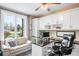 Functional home office with built-in cabinets, desk space, and a comfortable seating area at 12648 Waterside Ln, Longmont, CO 80504