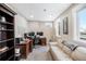 Home office with built-in desk, shelving, natural light from windows, carpet floors and sitting area at 12648 Waterside Ln, Longmont, CO 80504