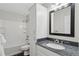 Bathroom featuring granite countertop, modern mirror and fixtures, and tiled tub at 7470 S Steele Cir, Centennial, CO 80122