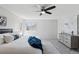 Bright bedroom with a ceiling fan, a window, and a dresser at 7470 S Steele Cir, Centennial, CO 80122