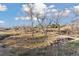 Scenic creek meandering through a grassy landscape with walking paths and mature trees, creating a peaceful environment at 7470 S Steele Cir, Centennial, CO 80122