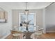 Cozy dining area with a round table, modern light fixture, and a window seat overlooking the backyard at 7470 S Steele Cir, Centennial, CO 80122