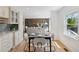 Elegant dining area with a view into the cozy living room, perfect for entertaining guests and Gathering at 7470 S Steele Cir, Centennial, CO 80122